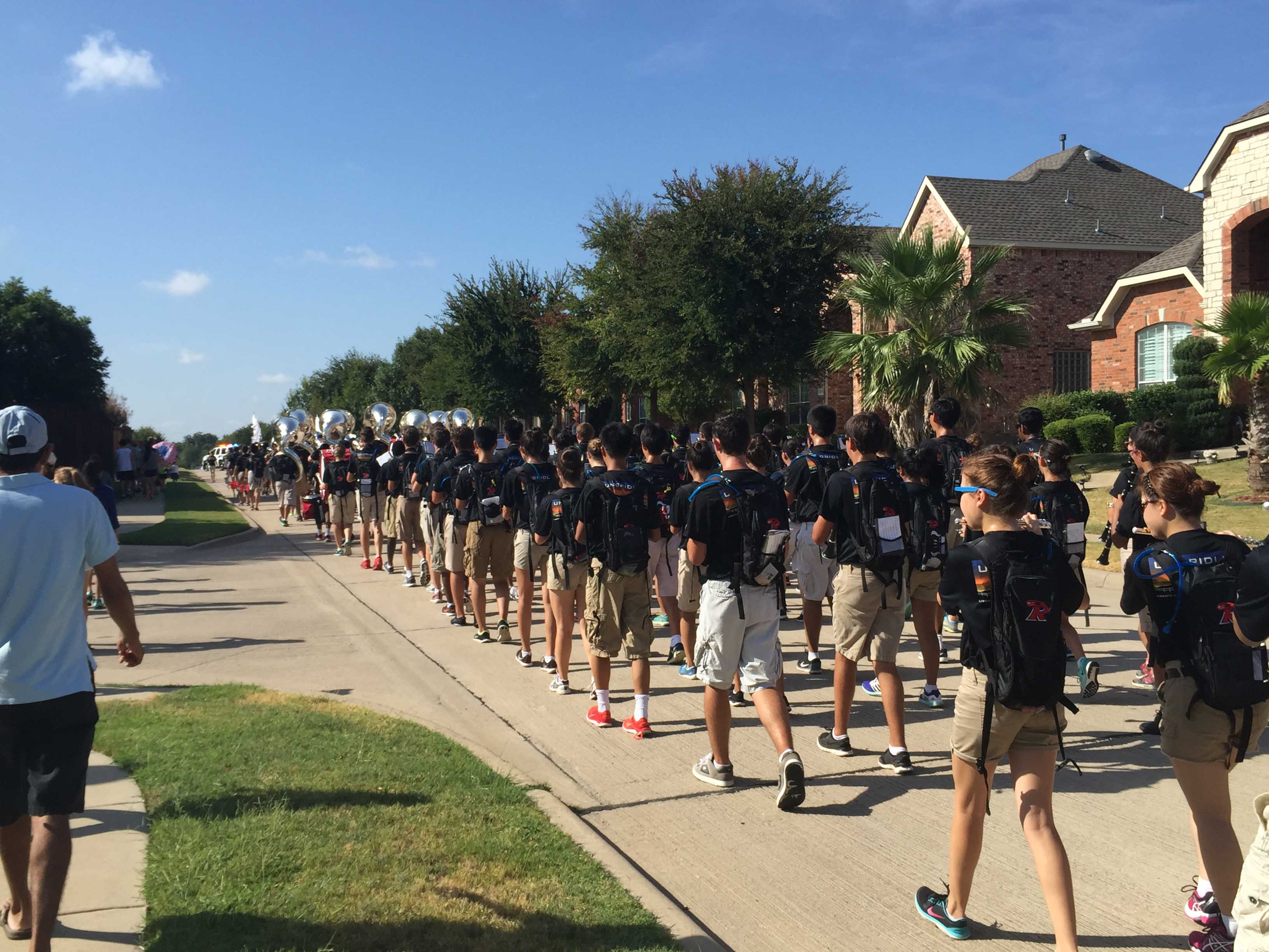 Making their way through the Turnbridge Manor and Hunters Creek neighborhoods, the school's marching band filled the street, temporarily preventing cars from driving down it. 