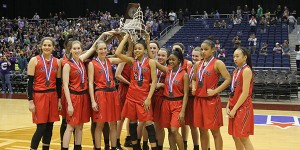 Falling to now 18-time state champion Canyon, the girls' basketball team lifts the 5A runner-up trophy at midcourt in the Alamodome in San Antonio. 