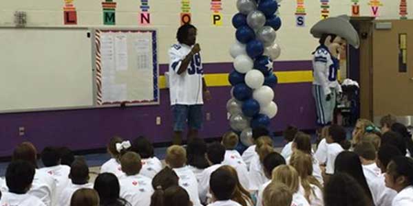 With a crowd of 5th graders looking on, Dallas Cowboys defensive back Brandon Carr spoke at Sparks Elementary School on Monday after as part of the Play 60 Challenge.