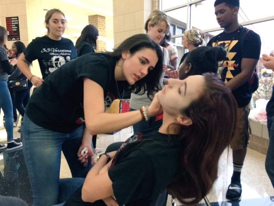 Students receive hauntingly seasonal face paint styled by the members of the Theatre department.