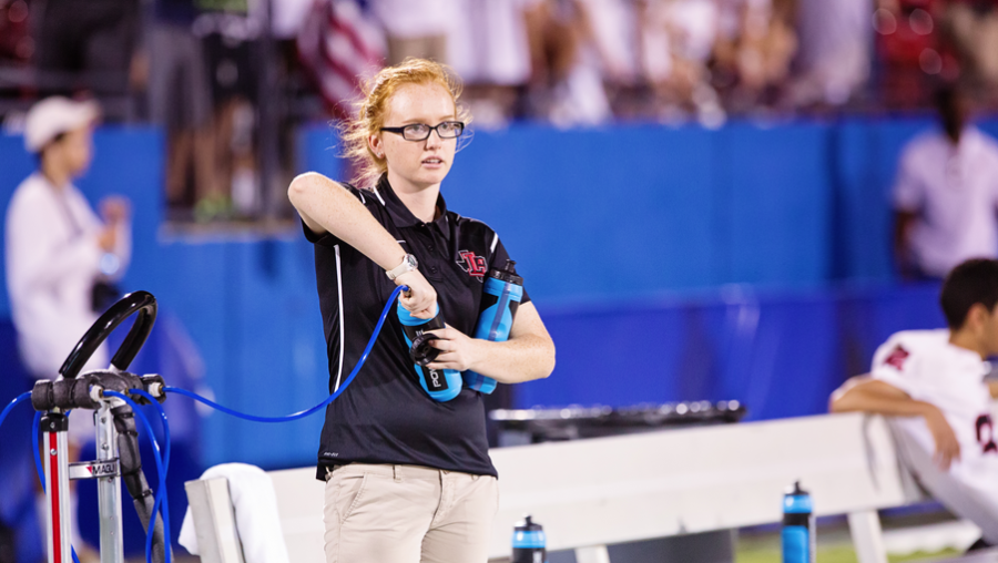 Filling water bottles for student athletes is only part of the job description for student trainers such as Derrica McDowell. The trainers are often the first ones out to the field and the last ones to leave.