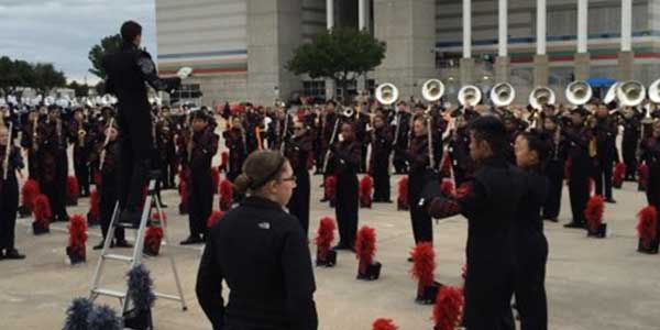 Prior to performing at the UIL Area Marching Band Competition in Carrollton, the band warms up in the parking lot outside Standridge Stadium.
