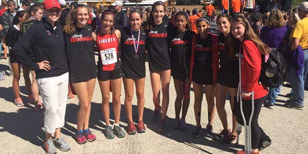 Members of the girls cross country team pose for a team photo with head coach Amanda Byers (far left) after the Regional Meet Monday in Grand Prairie. Three girls qualified for State along with two boys. 