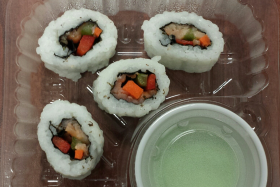 The sushi includes smoked salmon, carrots, and other ingredients wrapped in sticky rice. 