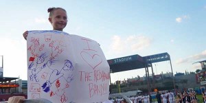 Whether the football is at Toyota Stadium or Memorial Stadium, odds are Emme Benton will be there holding up a sign or cheering on her favorite marching band. 