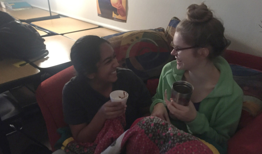 Seniors Amita Mallavarapu and Rebecca Gottschalk snuggle up and share hot chocolate one of Ms. Whalings love seats.