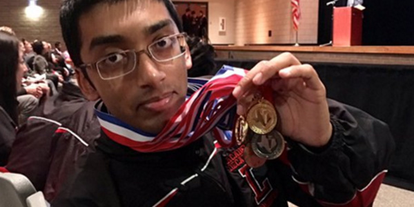 Showing off his various medals, senior Abel Sen set a school AcDec record with 9302.8 points in the regional competition. 