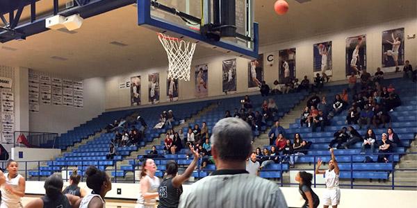 Players battle for rebounding position in the opening round of the 5A girls basketball playoffs at Plano West. 