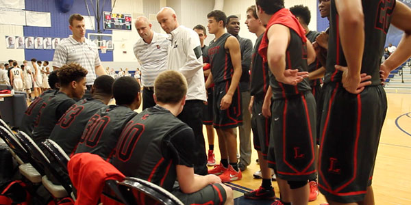 During a break in the action Tuesday night against Lone Star, head basketball coach Marcus Eckert talks to the team. 