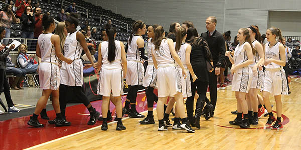 During a break in the girls 62-51 win over previously unbeaten Mansfield Timberview, the team comes together during a timeout. 