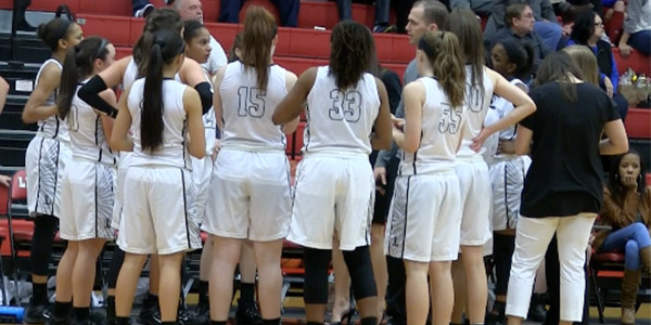 The girls huddle during a break in action on Tuesday night at the Nest. In their final regular season game of the year the team  got the best of Frisco 57-38.