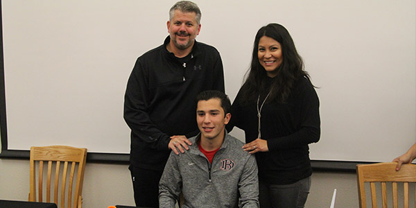 Senior midfielder Seth Picasso poses with his parents after signing with Dallas Baptist University