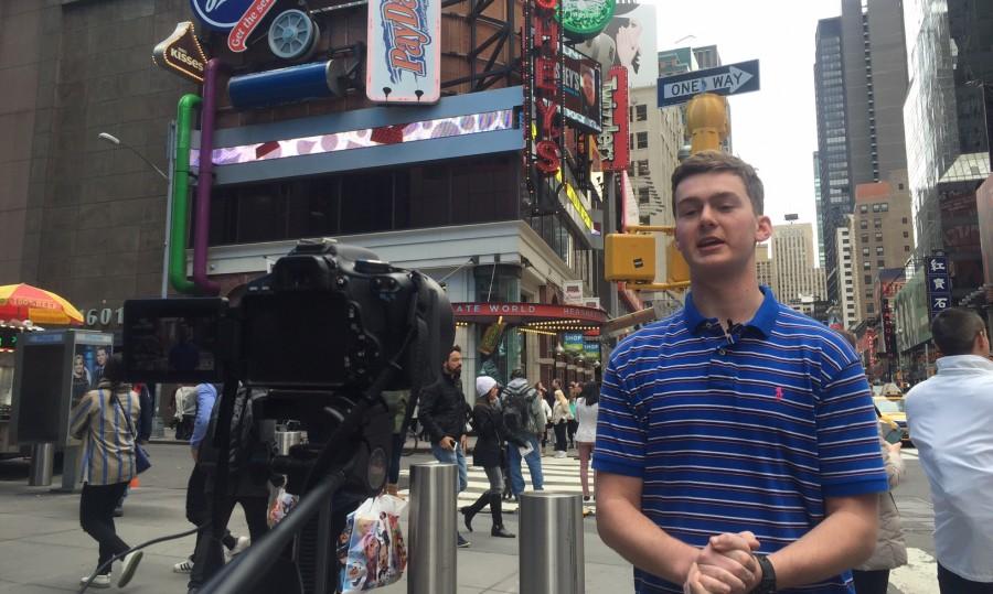 Among the foot traffic of Times Square, Senior Alex Moore films the daily update for Thursdays school day to be published online from New York.