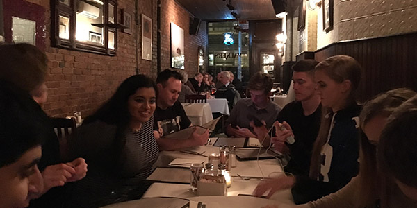 Moments before the challenge of hang up and hang out was issued, Wingspan staff members talk and look at menus on their first night in New York City for the Columbia Scholastic Press Association Spring Convention. 