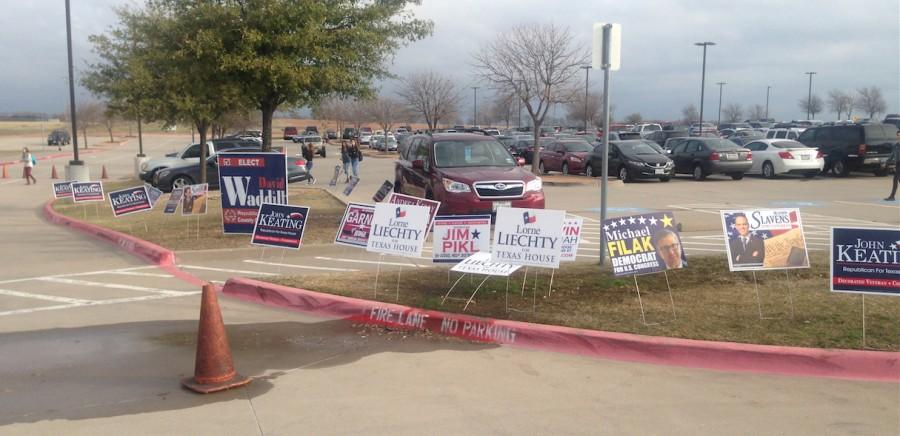 Political signs promoting candidates litter the east parking lot as students arrive to school.