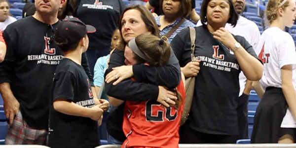 After losing to Canyon 41-34 in the 5A state championship,      freshmen Mara Casey gets a hug.