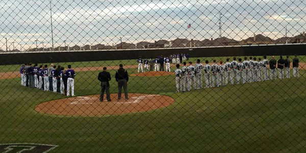 With the national anthem playing, the baseball team lines the right side of the field as Independence lines up along the third base line prior to the start of Fridays 9-3 win over the Knights. 