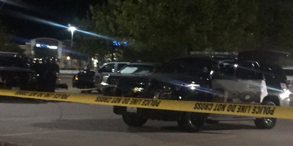 Police tape and police cars surround the silver Honda Pilot where the body of Christine Woo was found Thursday evening in the parking lot in front of the Target at 121 and Custer Road. 