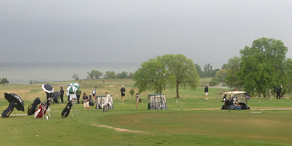 Despite the falling rain,  competitors in the boys 5A Region II golf tournament hit the driving range before teeing off in Mondays first round at Rockwall Golf and Athletic Club.