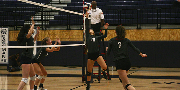 Ashley Pennington jumps to save a tight ball at the net. 