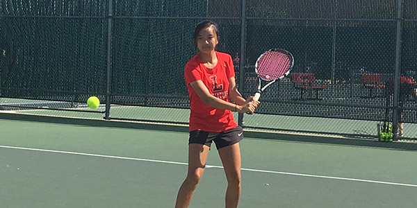 Practicing during 4th period, junior Tiffany Guan is a key member of the tennis team which is undefeated in District 13-5A.