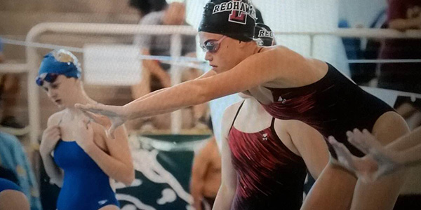 Getting ready to dive into the pool during a meet, junior Julia Cole has been swimming for 10 years. 