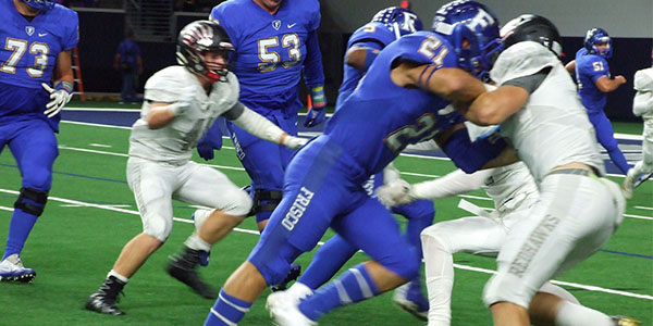 With Frisco driving towards the end zone, several defenders try to make the tackle. 