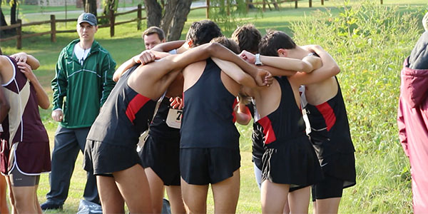 Varsity boys in a pregame huddle before their District 13-5A meet on Thursday.