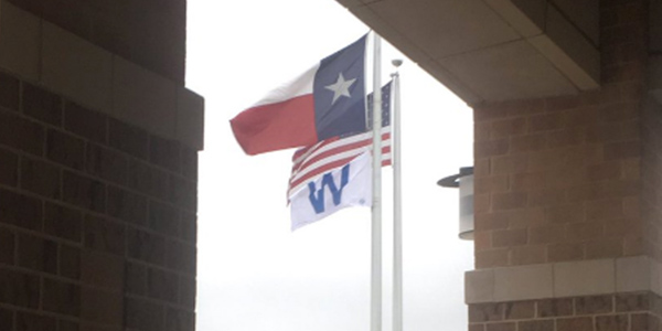 Temporarily joining the American flag and the Texas state flag is the Cubs win W flag. The flag is flying in honor of the Cubs first World Series win in 108 years. 