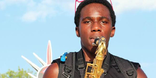Junior Nathaniel Ntuk playing his saxophone.