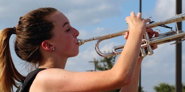 Freshman Phoebe Chalker playing her trumpet.