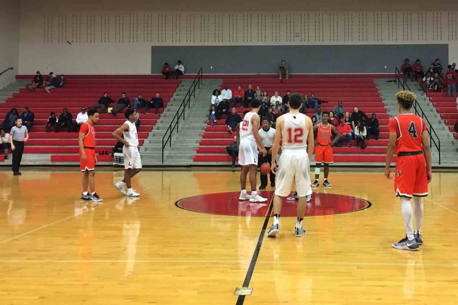 The boys basketball team gets ready for the tip in its triple overtime 97-94 loss to  Naaman Forrest.
