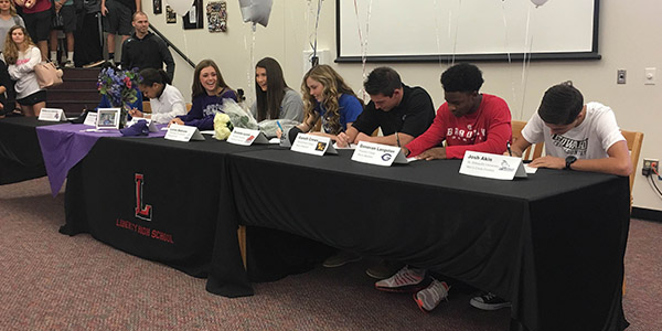 Eight seniors took part in Wednesdays National Letter of Intent  signing day in the library. 