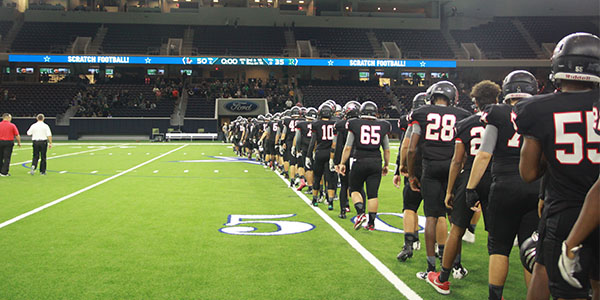 Winning its final game of the year 50-35 over Reedy, the team walks across the field at the Ford Center to shake hands. 