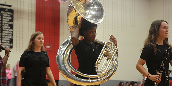 Taking their spots on the gym floor, the marching band gets ready to perform at the senior pep rally. 