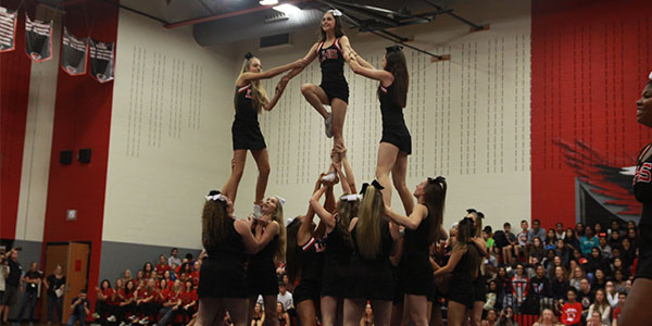 The cheerleaders perform a stunt during Thursdays senior pep rally. 