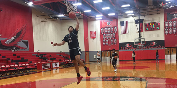 Junior David Russell goes in for a layup during practice prior to the team hosting Heritage in a District 13-5A game. 
