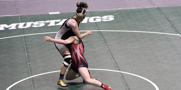 Senior Kyra Austin takes down her opponent at the State Semifinals last year.