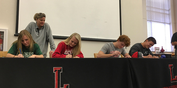 Four student athletes signed national letters of intent this morning to play sports in college.