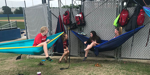 Taking a break before competing in the District 13-5A, junior varsity track and field athletes hang in hammocks at Memorial Stadium on Thursday, April 13, 2017.