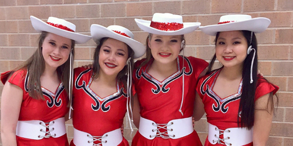 First from the left, freshman Emma Hancock smiles with her fellow dancers after the 2017 Spring Show.