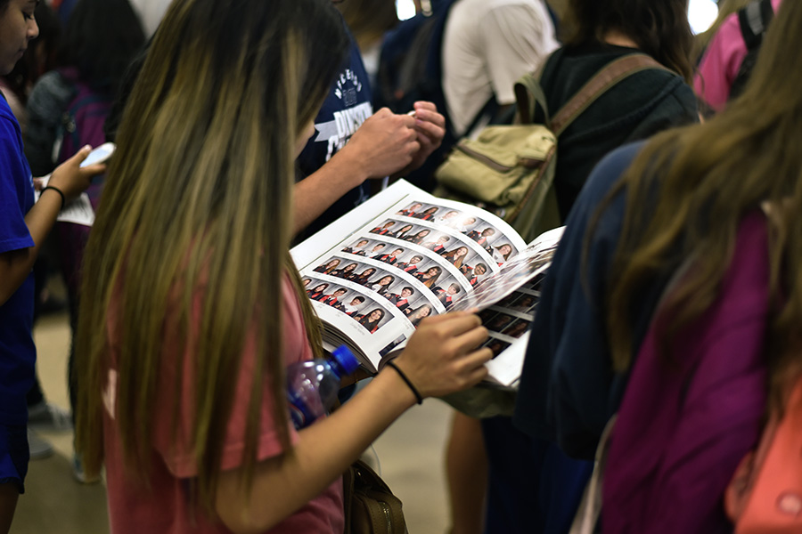 Almost instantly after picking up their yearbook, students immediately began flipping through the book. 