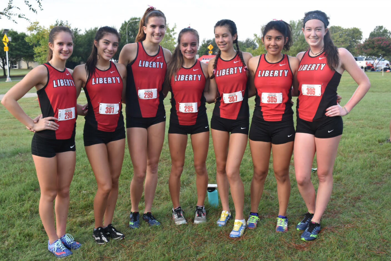 Second from the right, Ruiz  smiles for a picture with the cross country team at a meet.