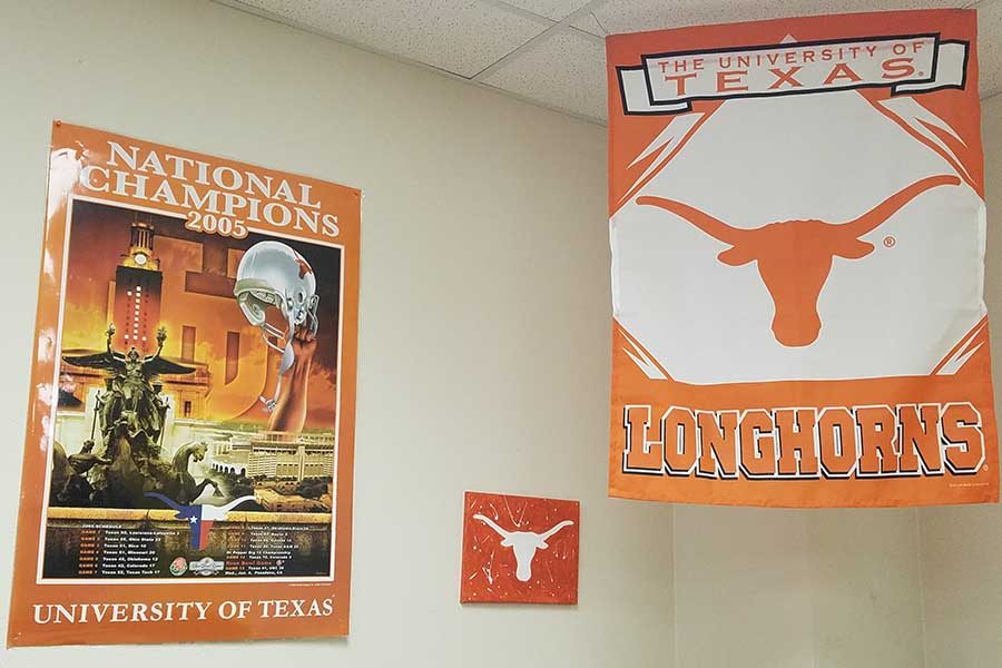A UT banner and poster adorn the walls of social studies teacher Gary Mumford. The district is holding a Texas Trio virtual event for seniors to learn about UT, A&M, and Texas Tech.