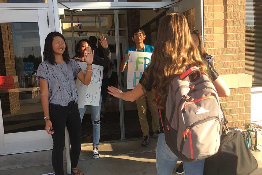 Members+of+Pulse+greeted+students+Friday+morning+with+high+fives.+