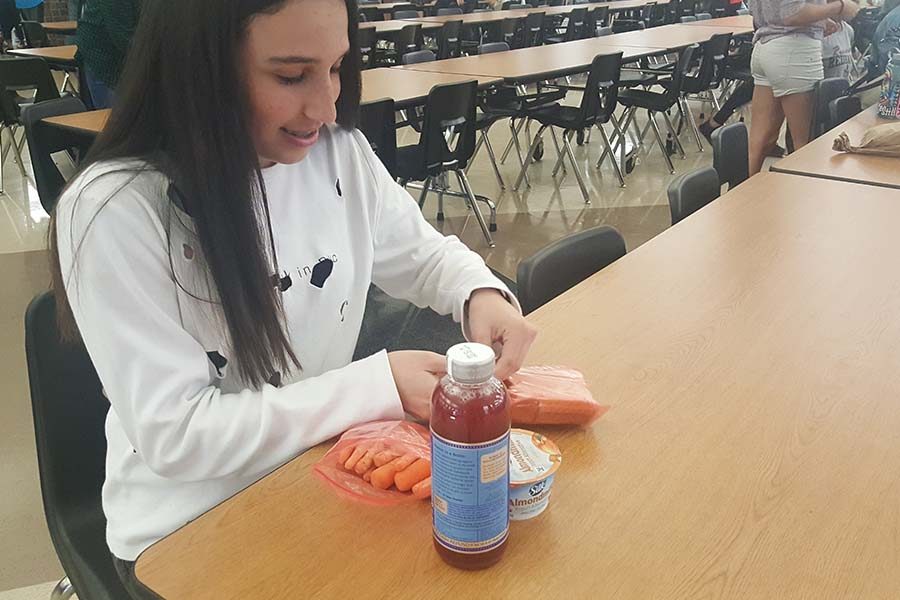 Sitting down for lunch, junior Katharina Santos began a vegan diet after watching a documentary on Netflix called “What The Health.