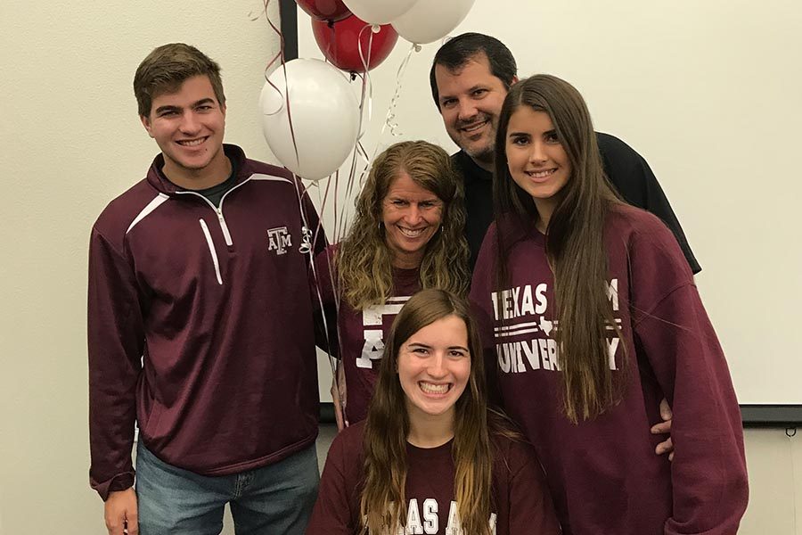 Surrounded by her brother John, mom Pam, dad Jack, and sister Kristen, senior Carrie Fish committed to Texas A&M on Wednesday as she will continue her cross country and track career in College Station starting in 2018. 
