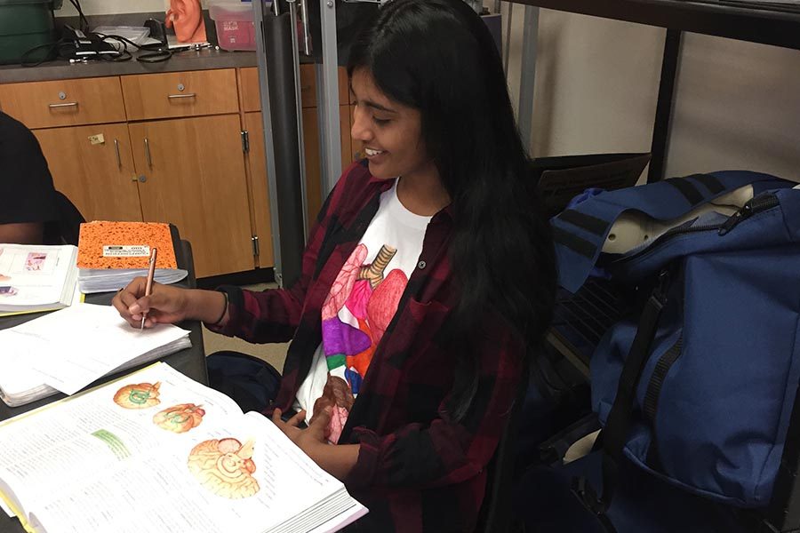 Working on an assignment, freshman Siri Kothapalli wears her Medical Terminology interactive t-shirt on Thursday, Feb. 8, 2018. 