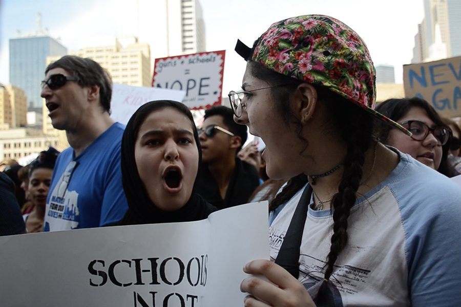 Leading a chant within the crowd, juniors Amina Syeda and Dena Asad engage with other protesters.