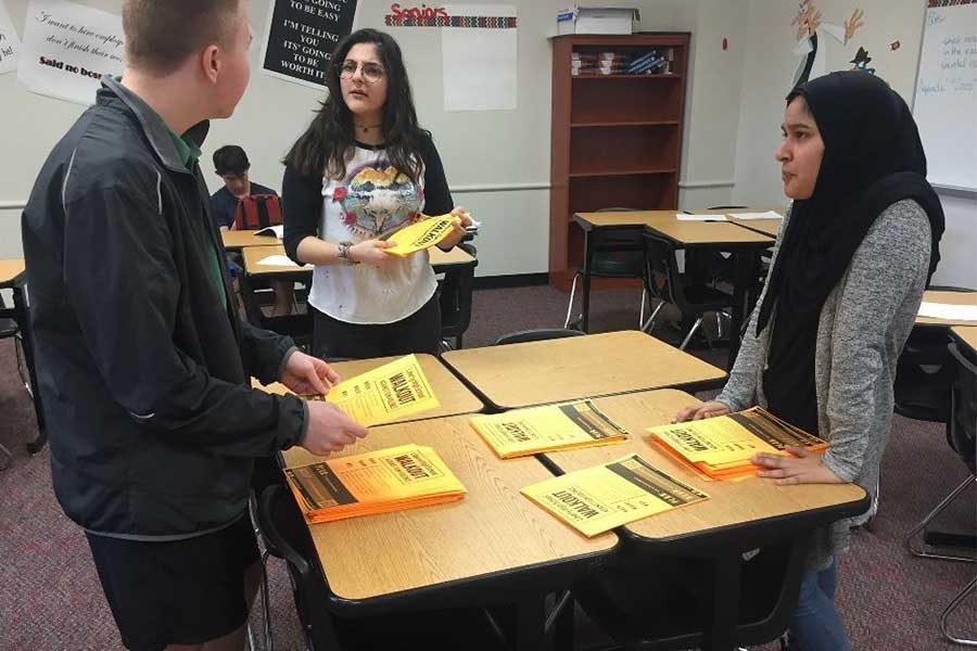 With stacks of flyers detailing the student led walkout scheduled for April 20, senior Parker Butler, along with juniors Dena Assad and Amina Syeda discuss their plan for handing out the flyers and raising awareness for the event.